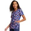 Cherokee Infinity Womens V-Neck Print Scrub Top with 2 Pockets, Rib-Knit Insert Logo O-Ring Detail & Shirttail Hem – CK634(Sporty Spots)